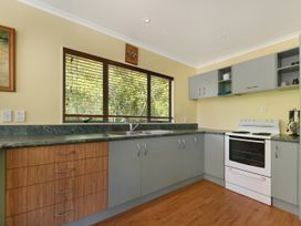 A kitchen with cabinets and an oven at Picton in Picton