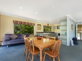 A kitchen with a dining table and chairs at Picton in Picton