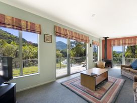 A living room with a television and a table at Picton in Picton