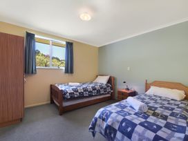 A bedroom with two beds and a nightstand at Picton in Picton