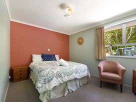 A bedroom with a bed and bedside table at Picton