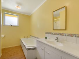 A bathroom with a bathtub and sink at Picton in Picton