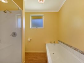 A bathroom with a bathtub and shower at Picton in Picton