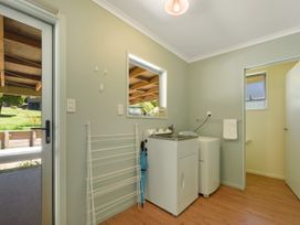 A laundry room with a washing machine and sink at Picton in Picton