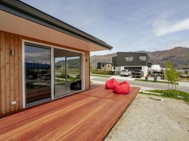 A deck area with bean bags and a view of mountains at Skiwi - Wanaka Holiday Home Wanaka