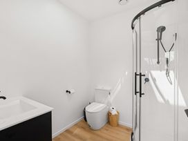 A bathroom with a shower and toilet at Skiwi - Wanaka Holiday Home in Wanaka