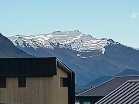 A view of mountains with snow at Skiwi - Wanaka Holiday Home in Wanaka