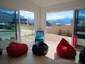 A living room with bean bags and a chair at Skiwi - Wanaka Holiday Home, Wanaka