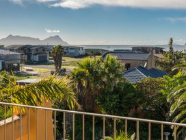 A view of houses and sea with mountains in the distance at Ruakaka