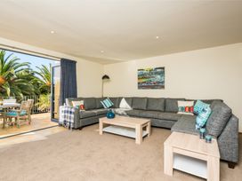 A living room with a sofa and coffee table at Ruakaka