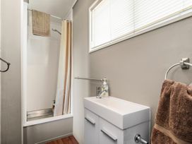 A bathroom with a shower and sink at Lakepath Retreat - Lake Rotoiti Holiday Home Rotoiti Forest