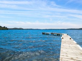 A pier extending into a lake at Lakepath Retreat - Lake Rotoiti Holiday Home Rotoiti Forest