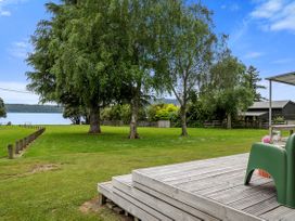 A view of trees and lake from a decking area at Rotoiti Escape - Lake Rotoiti Holiday Home