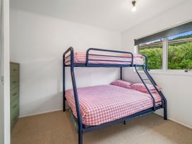 A bedroom with a bunk bed and a dresser at Rotoiti Escape - Lake Rotoiti