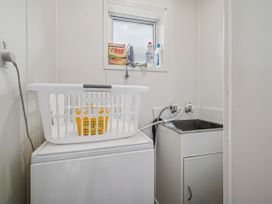 A laundry room with a washing machine and sink at Rotoiti Escape - Lake Rotoiti