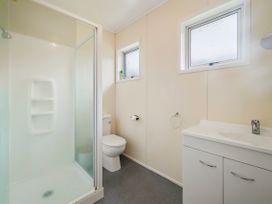 A bathroom with a shower, toilet, and sink at Rotoiti Escape - Lake Rotoiti