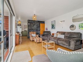 A living room with a sofa and coffee table at Rotoiti Escape - Lake Rotoiti