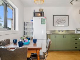A kitchen with a table and chairs at Rotoiti Escape - Lake Rotoiti