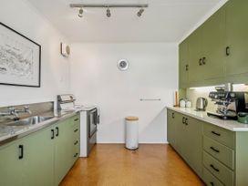A kitchen with a sink, stove, and coffee maker at Rotoiti Escape - Lake Rotoiti