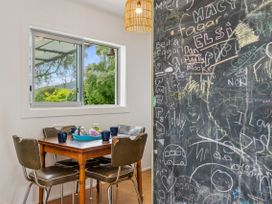 A dining room with a table and chairs at Rotoiti Escape - Lake Rotoiti Holiday Home