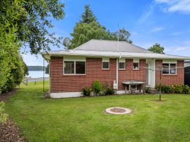 A house with a table and clothesline at Rotoiti Escape - Lake Rotoiti Holiday Home Lake Rotoiti