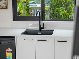 A kitchen with a sink and window at Lake Taupo Holiday Home in Motuoapa