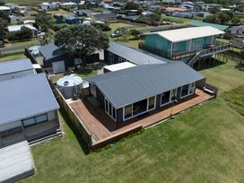 An outdoor view of houses and deck at Karikari in Kaitaia