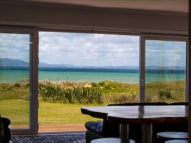 A view of the ocean through a window at Karikari in Kaitaia