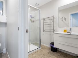 A bathroom with a shower and toilet at Karikari in Kaitaia
