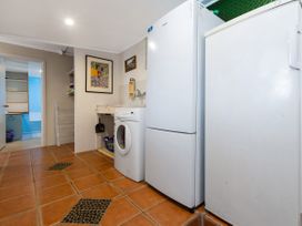 A laundry room with appliances at Karikari in Kaitaia