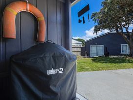 An outdoor area with a grill cover and life buoy at Karikari in Kaitaia