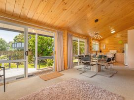 A dining area with a table and chairs at Sea Breezes - Matarangi Holiday Home Whitianga