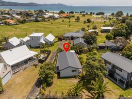 A view of houses and a playground at Sea Breezes - Matarangi Holiday Home Whitianga