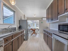A kitchen with a dining area at Matarangi Holiday Home in Whitianga
