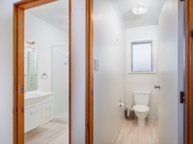 A bathroom with a vanity and shower at Matarangi Holiday Home in Whitianga