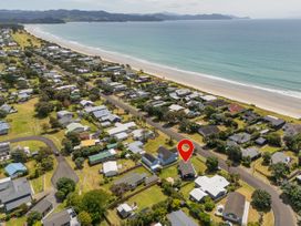 Aerial view of residential area and beach at Matarangi Holiday Home in Whitianga