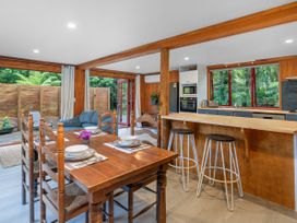 A dining room with a table and chairs at The Oak House - Coromandel
