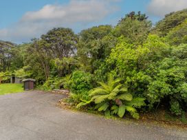 An outdoor area with trees and sheds at The Oak House - Coromandel