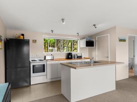 A kitchen with appliances and a sink at Waipu Holiday Home Waipu