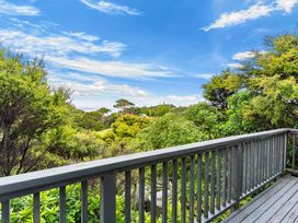 A view from a deck overlooking greenery at Waipu Holiday Home Waipu