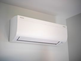 An air conditioner mounted on the wall at Te Anau Holiday Home in Te Anau