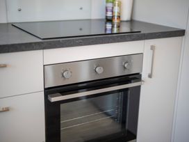 A kitchen with an oven and stovetop at Te Anau Holiday Home in Te Anau
