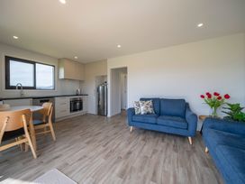 A kitchen with seating area and appliances at Te Anau Holiday Home in Te Anau