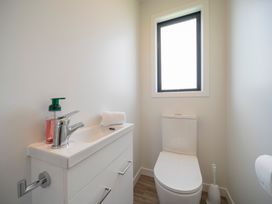 A bathroom with a sink and toilet at Te Anau Holiday Home in Te Anau