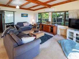 A living room with sofas and a coffee table at Seabreeze Hideaway - Golden Bay Holiday Home, Collingwood