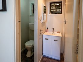 A bathroom with a toilet and vanity sink at Seabreeze Hideaway - Golden Bay Holiday Home, Collingwood