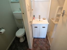 A bathroom with a sink, toilet, and shower at Seabreeze Hideaway - Golden Bay Holiday Home in Collingwood