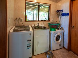 A laundry room with washing machine and sink at Seabreeze Hideaway - Golden Bay Holiday Home Collingwood