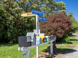 A row of mailboxes with directional signs at Seabreeze Hideaway - Golden Bay Holiday Home, Collingwood
