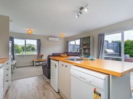 A kitchen with a sink and dishwasher at Cozy Cottage - Whitianga Holiday Home in Whitianga